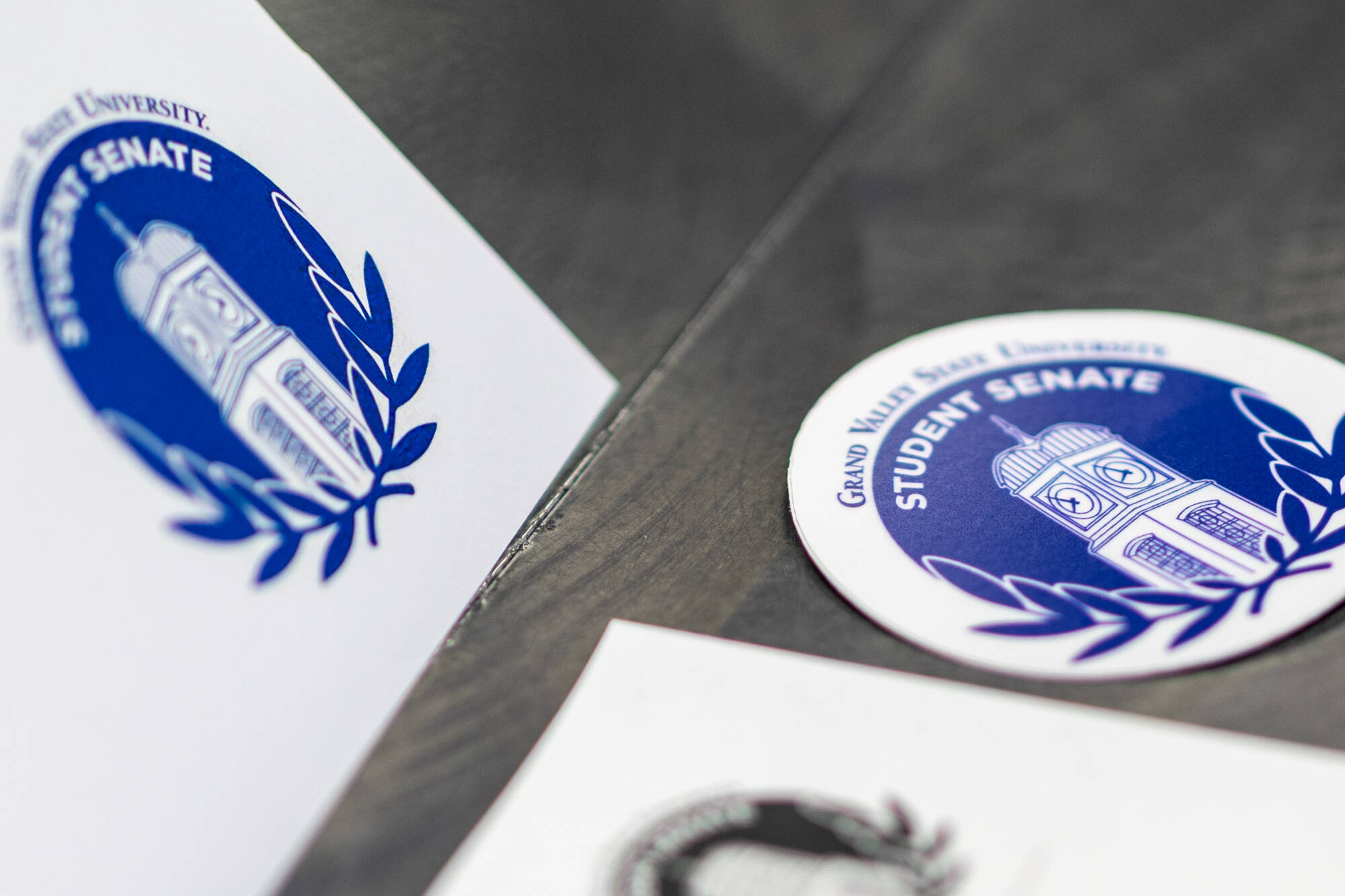 Student Senate logo sticker on a table during a meeting.